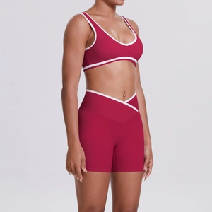 Detail of burgundy yoga set with U-neck bra and cross high-waisted shorts with white piping