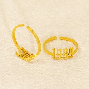 Golden 1999 and 2000 gothic year rings with adjustable bands in stainless steel
