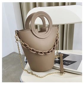 Detail view of khaki PU leather bucket bag with metal ring handle and resin chain