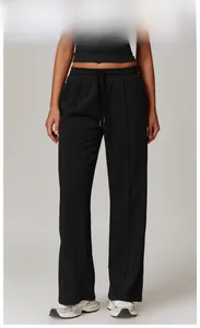Detail view of high-waisted black lounge pants featuring elastic drawstring and vertical pleats