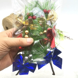 Artificial pine needles stems with berries and metallic bows for Christmas tree decor