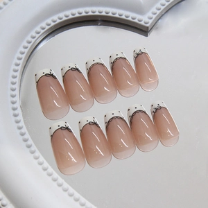 French bow press-on nails with white lace and black dots in long coffin shape