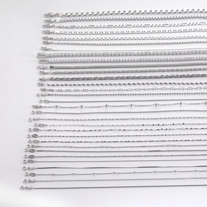 Detailed macro shot of assorted S925 sterling silver chain styles with high metallic luster