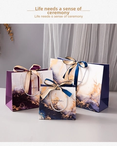 Three sizes of luxury marble pattern gift bags with Sweet Times text and silk ribbons