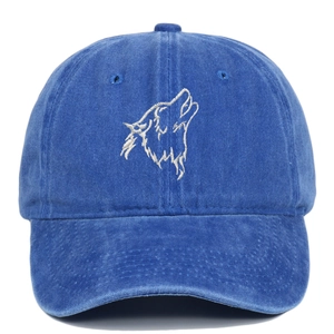 Close-up of royal blue washed cotton baseball cap with white wolf head embroidery