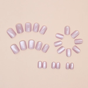 Detailed set of cat-eye press-on nails in lavender pink with shimmering glass bead finish