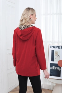 Detail of red hooded jacket showing leopard print lining and premium windproof fabric