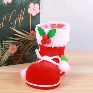 Red flocked Christmas boot candy container with white fur trim and green holly leaf accents