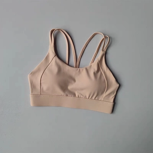 Flat lay of nude high-impact sports bra featuring double straps and crisscross back detail