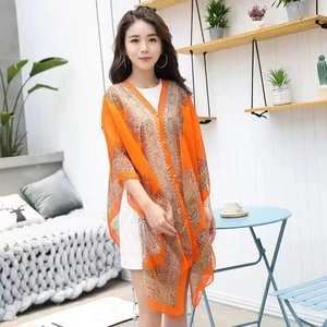 Detail of orange paisley chiffon sunscreen shawl with loose V-neck bohemian design
