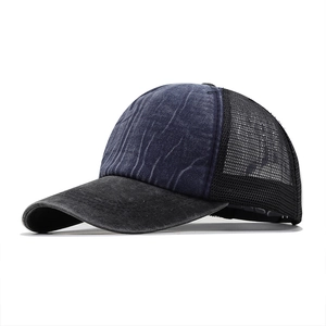 Close-up of vintage washed denim trucker hat showing mesh back and durable stitching