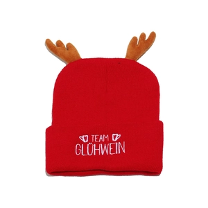 Detail of red Christmas knit hat with brown antlers and Team Glühwein white embroidery