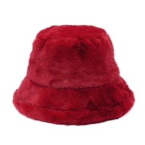 Macro shot of deep red plush faux fur fisherman hat showing soft texture and thick material