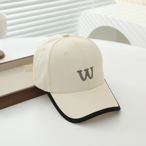 Detailed view of cream cotton baseball cap with grey 3D embroidered letter W and black trim