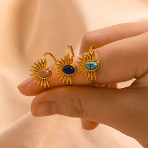 Bohemian sunburst open ring in gold finish with turquoise inlay on a female finger