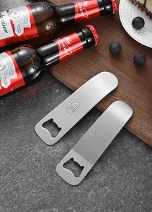 Flat stainless steel beer bottle openers with 304 SUS engraving on dark stone surface