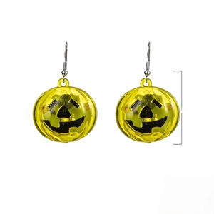 Detail view of glowing Halloween pumpkin earrings showing 1.3 inch size and weight 10.3g