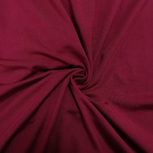 Detail of burgundy ruched fabric showing smooth texture and elegant drape for dresses