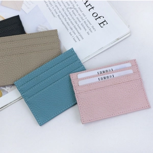Close-up of pebble grain leather card holders in pink, blue, khaki and black colors