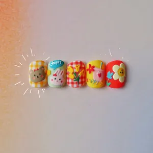 Close-up of embossed hand-drawn bear and rabbit nail art stickers for kids journaling
