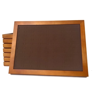 Walnut wood jewelry tray detail with microfiber slots for rings and cufflink display