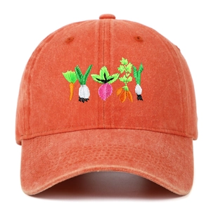 Detail of vintage washed orange cotton baseball cap with vegetable embroidery