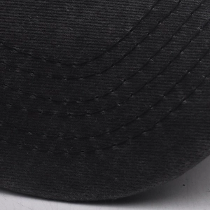 Detail of classic black twill cotton baseball cap brim with parallel stitching lines