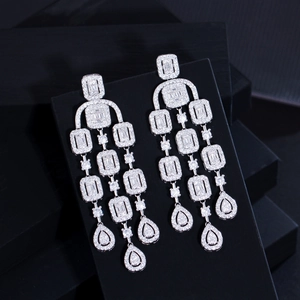 Elegant silver tassel earrings with zircon pavé stones shown on a black display box