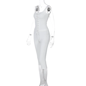 Detail of white ribbed knit sleeveless romper featuring lace-up chest and waist drawstring