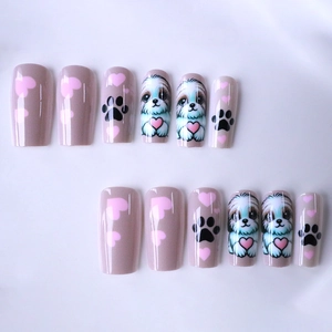 Coffin press-on nails with cute puppy dog, paw prints, and pink heart designs on tan base