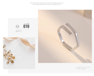 Macro detail of geometric hexagonal silver ring with zircon inlay and open design
