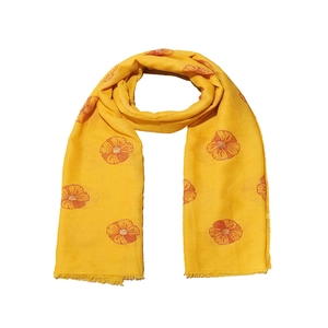 Detailed view of yellow floral scarf with orange flower print and frayed edge design