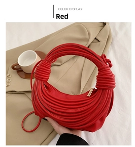 Detail of red knotted shell bag featuring unique cord knotting on beige blazer