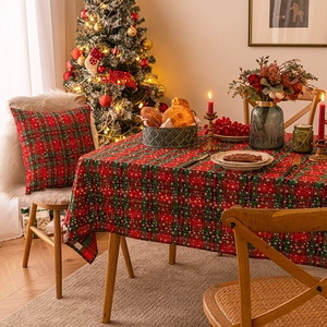 Christmas plaid tablecloth with snowflake patterns and matching pillows in a festive setting