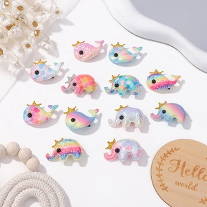 Detail view of colorful glitter animal hair clips with crown and rainbow gradient pattern
