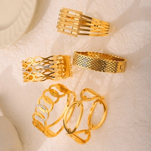 Four 18K gold plated geometric bangles with zircon inlay on a minimalist background