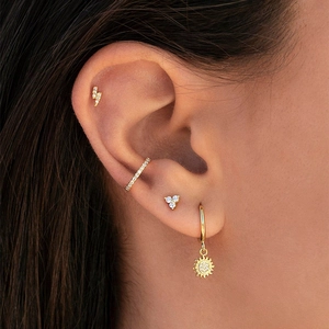 Golden earrings set featuring sun pendant and lightning studs with white zircon inlay