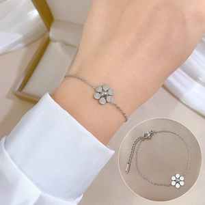 Silver petal-shaped bracelet with adjustable clasp shown on wrist and flat lay detail