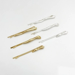 Minimalist irregular wave alloy hair clips in gold and silver finishes on white background