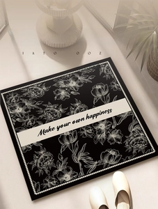 Detail of square diatom mud bathroom mat with floral print and inspirational quote