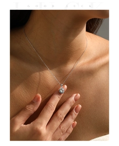 Close-up of S925 silver hexagonal pendant with sparkling central stone on model neck