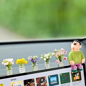 Luminous miniature flower vases with anime figure on a car dashboard for decoration
