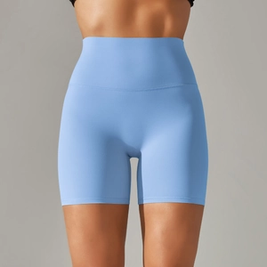 Detail view of high-waisted light blue yoga shorts showing seamless texture and wide waistband