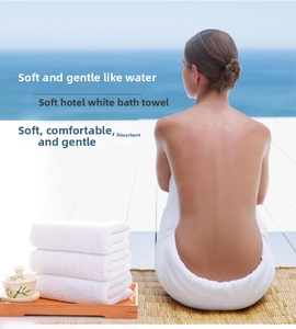 Close-up of white luxury cotton hotel towels showing fluffy texture and soft loops
