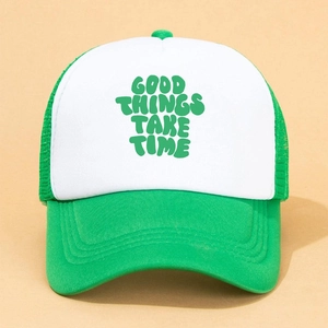 Detailed front view of green and white mesh trucker hat with Good Things Take Time slogan