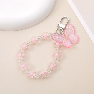 Macro detail of acrylic bead chain with pink iridescent butterfly pendant and metal hook