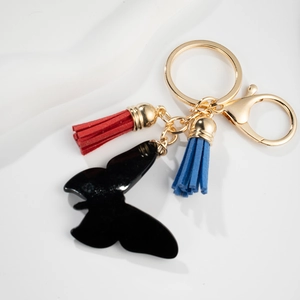 Fashionable gold butterfly keychain with black insect pendant and colorful tassels
