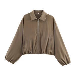 Detail shot of a cropped brown baseball jacket with zip-up front and pleated hemline