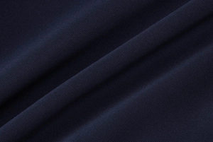 Close-up of navy blue knit fabric showing detailed texture and soft natural folds
