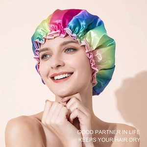 Rainbow satin waterproof shower cap worn by a smiling model to keep hair dry in the bath
